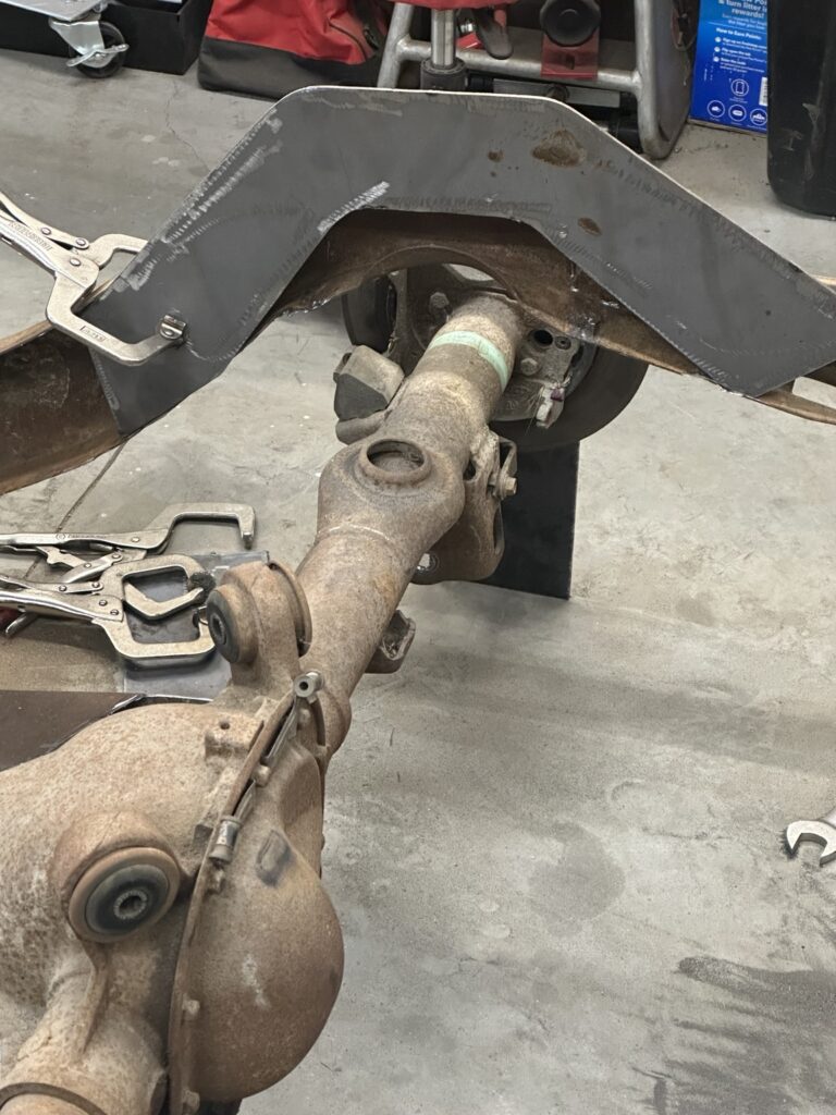 C-notch side plate clamped in position over the rear axle.