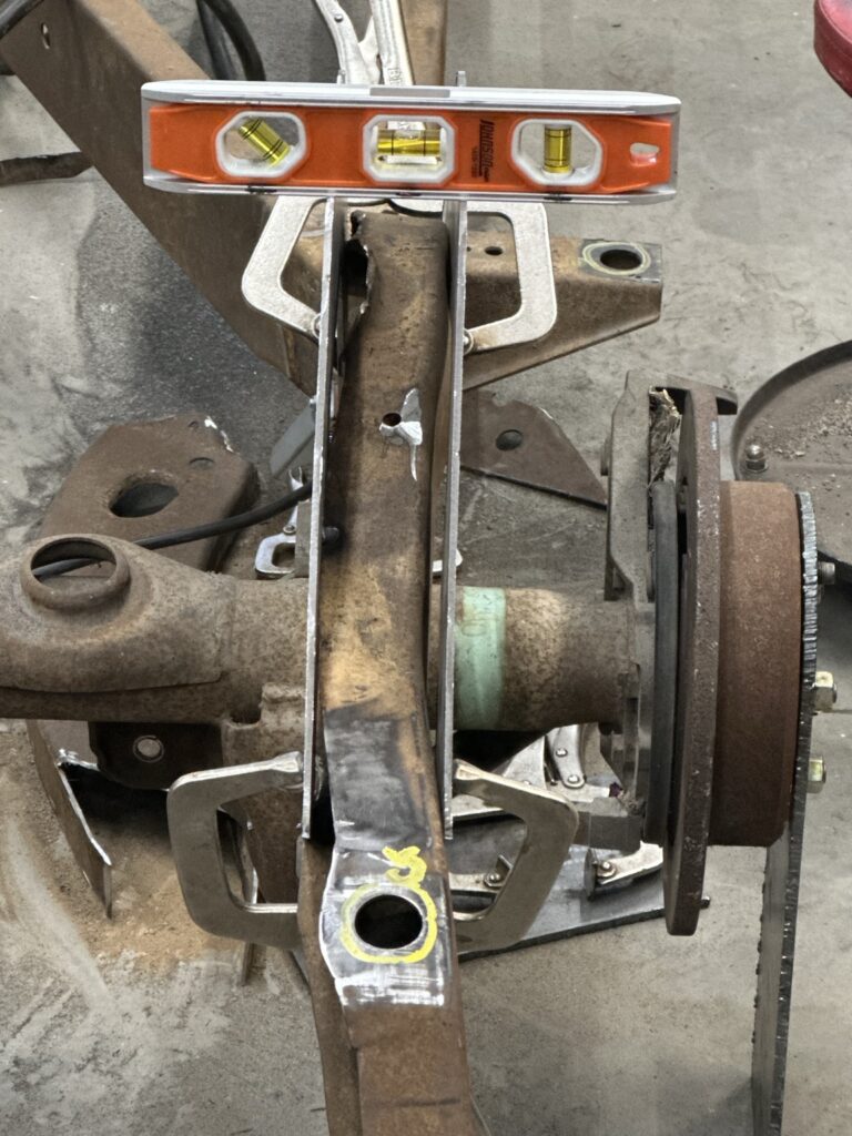 Checking the clamped plates with a level during fit-up.